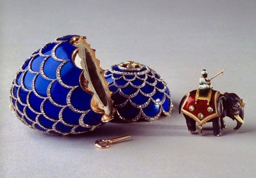 The egg was created by workmaster Michael Perkhin and is crafted of gold, silver, rose-cut diamonds, brilliant diamonds and translucent royal blue enamel. The miniature elephant is made of silver, gold, ivory, rose-cut diamonds and red and green enamel.