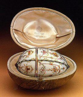 It is made of gold, diamonds, chalcedony, pearls, transparent white enamel, a velvet. The miniature box "surprise" inside the main box/ egg is made of agate and has been decorated with brilliant cut stones and a cabochon ruby. Inside this there is a pendant of gold and enamel.