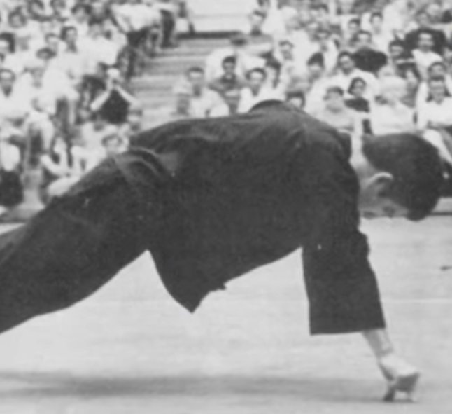BRUCE LEE DOING ONE HAND PUSH UPS, USING ONLY AN INDEX FINGER AND A THUMB.