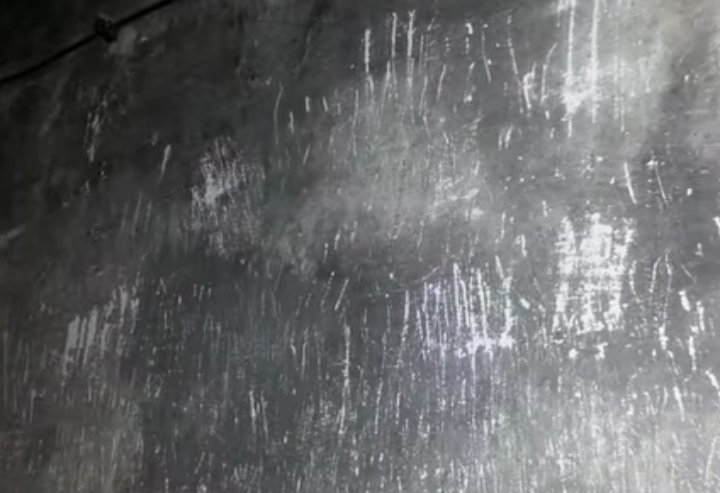 NAIL MARKS ON THE WALLS OF AUSCHWITZ GAS CHAMBER.
