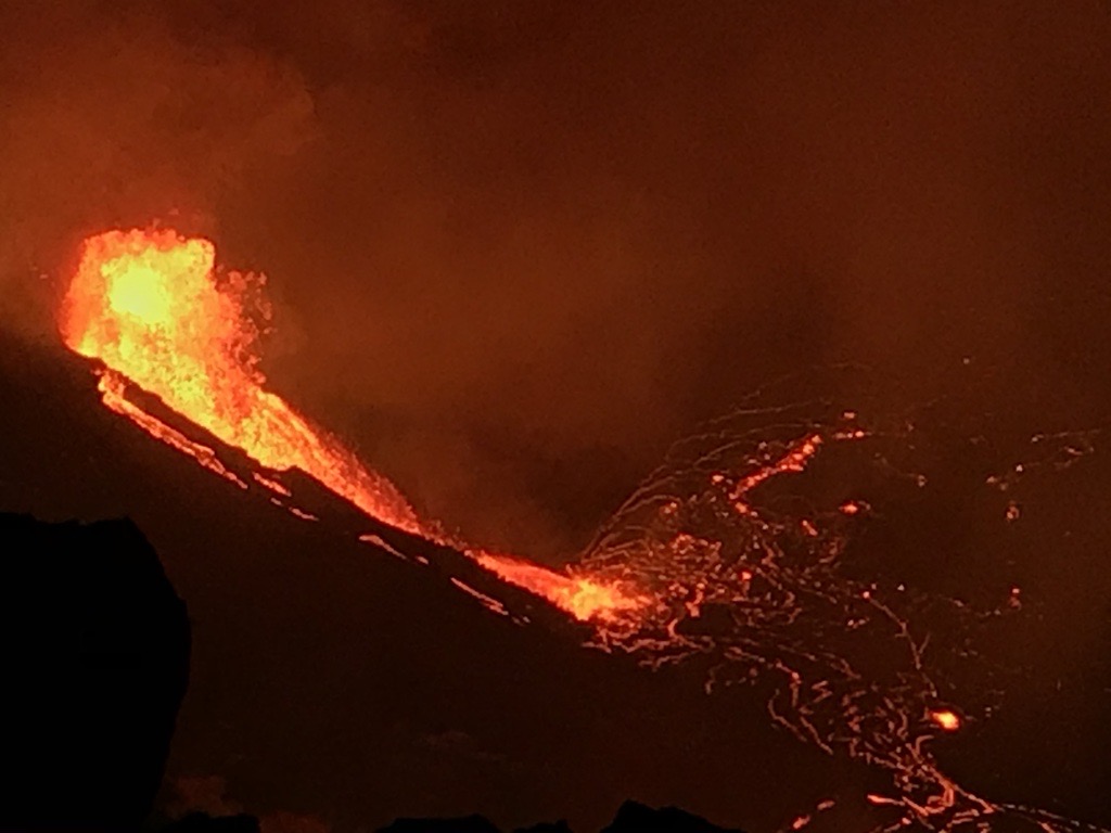 View from the W rim of Kīlauea Caldera just before 5 a.m. HST on Dec. 21, 2020. The main fountain height is ~18 m (59 ft) and with two other fissures feeds a growing lava lake at the base of Halemaʻumaʻu crater. Volcanic gas continues to travel downwind, southwest of the vents.