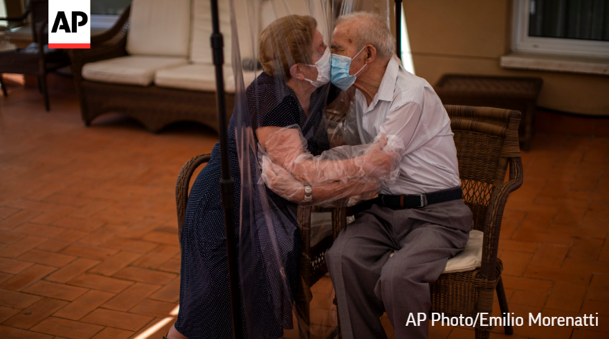 Agustina Canamero, 81, and Pascual Perez, 84, hug and kiss through a plastic film screen to avoid contracting the coronavirus at a nursing home in Barcelona, Spain, in June.

#APPhotos2020'