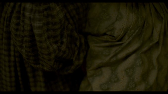  #Ammonite returns to shots of the hems of dresses & clenched hands just prior to cunnilingus between women. We saw similar images when one cried out in grief. The floral dress was once shot alone. Now, it presses against another. Transgressive sexuality is an end to solitude.