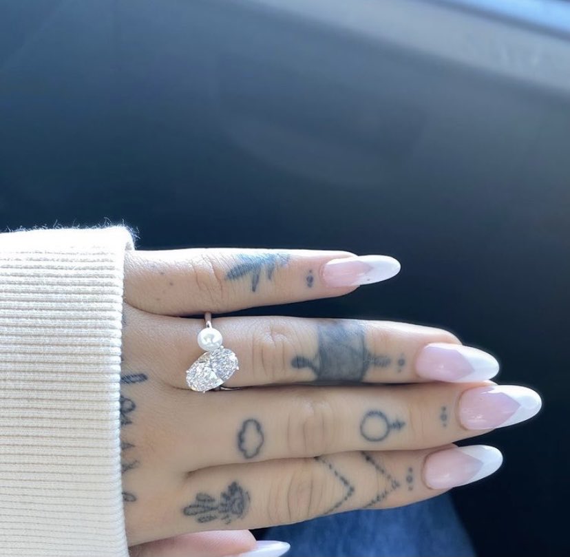 The “Positions” singer shared some adorable snaps of her cuddling her fiancé, complete with a close-up picture of the dazzling new addition on her finger! 💍
