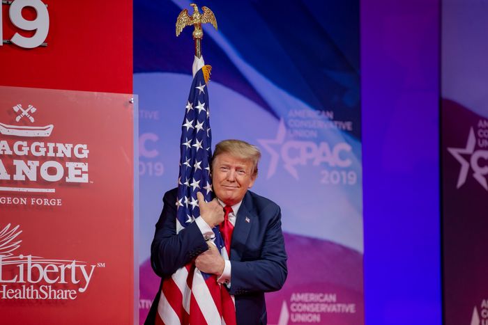 March 2, 2019: President Trump spots a beautiful flag after walking onstage at CPAC and just starts hugging it  http://nym.ag/38tsOtU 