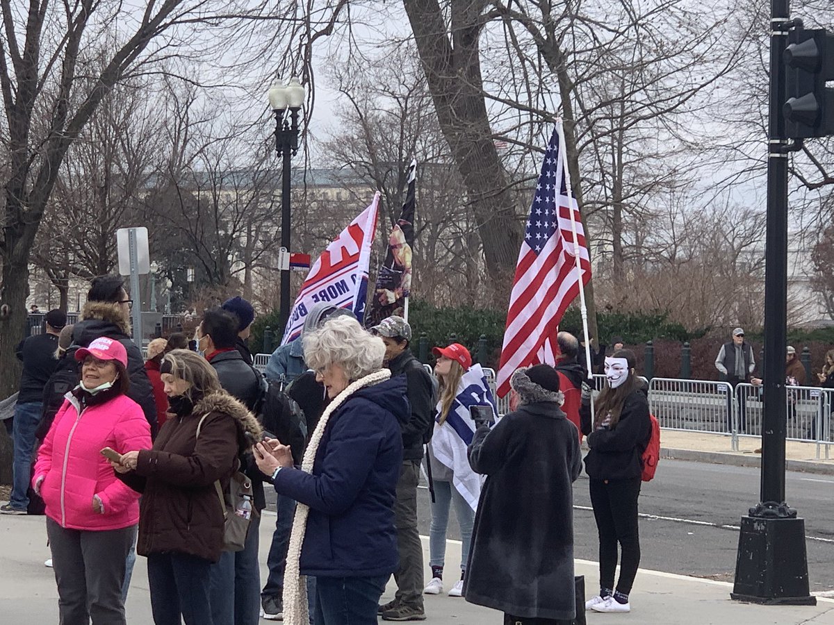 Another person is brandishing an American flag and wearing…a Guy Fawkes mask?There’s a lot going on here, people.