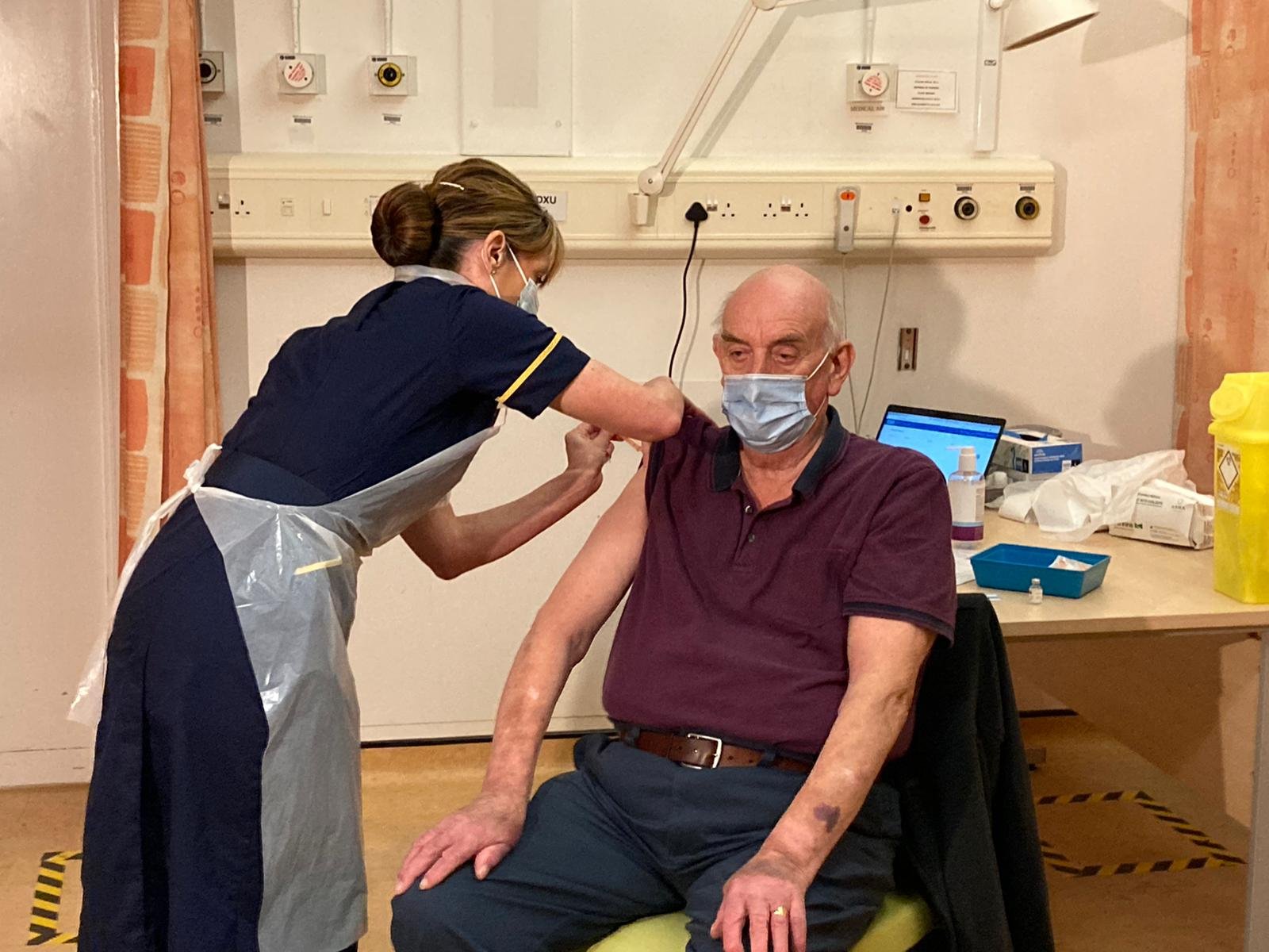 Image of Brian Pinker receiving the first dose of the Oxford AstraZeneca vaccine today, with Chief Nurse Sam Foster administering the jab. 