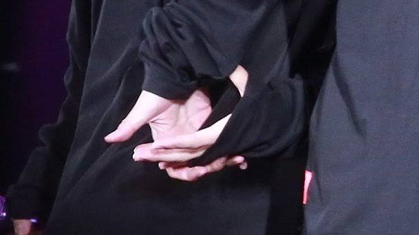 intertwining their hands