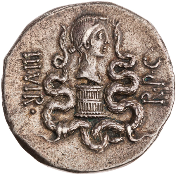 This is also clearly evidenced by the Reverse of the coin, where a Cista mystica is surmounted by bust of Octavia - Antony's wife, and the sister of Octavian - and flanked by serpents. The Legend is III.VIR.R.P.C. - 'Triumvir for the reconstituting the Republic'.