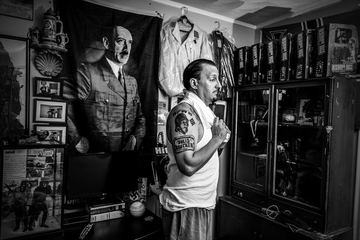 Anthony Petruccelli, of Lynn, MA, member of the National Socialist Movement, surrounded by his Nazi paraphernalia