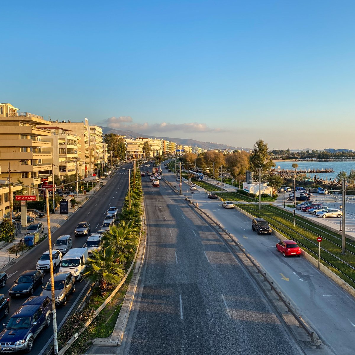 Final image from a bridge built to maximize traffic flow: city on the left, beach on the right. It took me years to see the absurdity in this design—six traffic lanes, two shoulder lanes, the tram, a tiny sidewalk, then parking. Cars over people, the city cut off from the water.