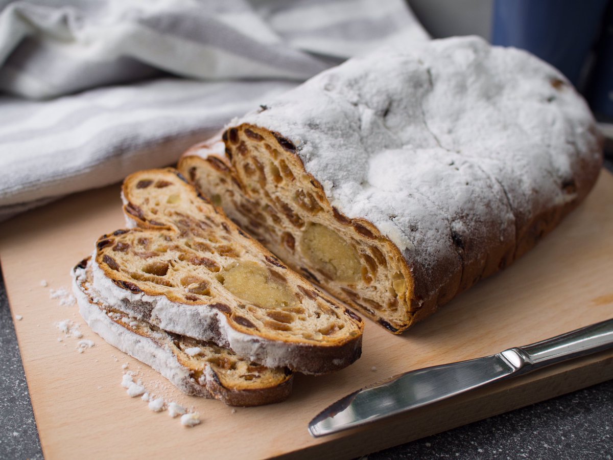 This is “kerststol” (Christmas clot) a traditional Dutch delicacy eaten at Christmas and Easter (“paasstol”). By law, the Dutch are only allowed to eat marzipan and powdered sugar between Christmas and Easter, otherwise their combined weight would cause the country to subside.