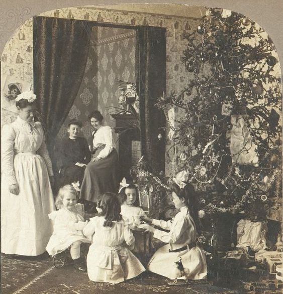 A family in London, England watch the children open their Christmas gifts in 1908.