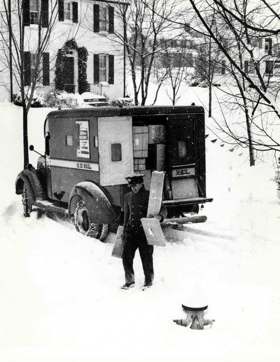 A mailman delivers packages before Christmas in 1933.