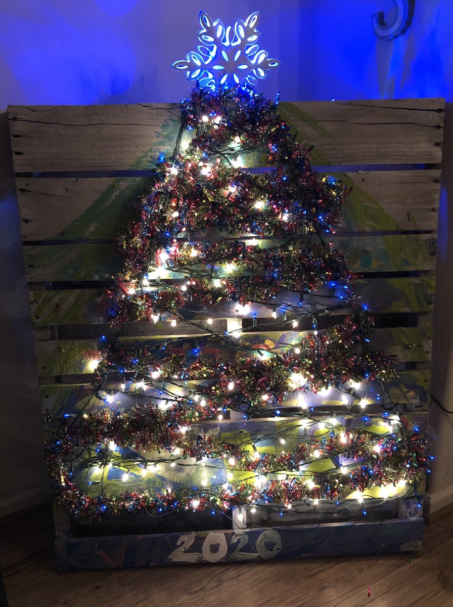 RedMillPE's tweet photo. So, @SheilaVBHPE gave us a pallet to make amazing outdoor furniture with. Well, 2020 happened &amp; my sweet Gavin didn’t want to kill another tree, so.... BEST CHRISTMAS TREE EVER!!! #ourkitchentilewasuglyanyway  #redmillrocks #bestchristmastreeever https://t.co/rGJcHnDEIm