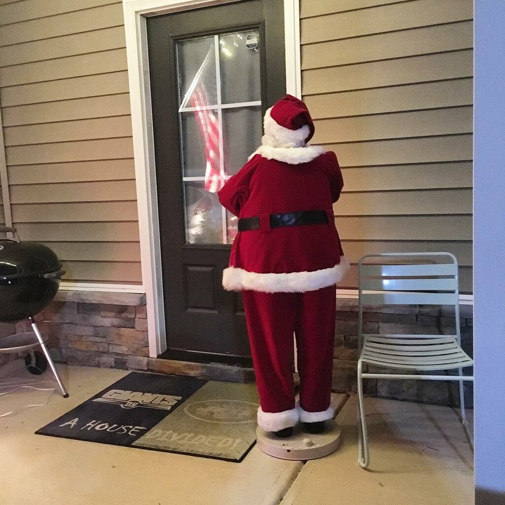 Santa on the porch of someone's home.