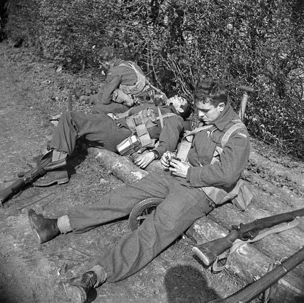 Privates R.E. Lodwick and Mac McKinnon of the Lincoln and Welland Regiment resting after driving German paratroops out of Wertle, Germany, 11 April 1945.

amzn.to/2KZ7C6X