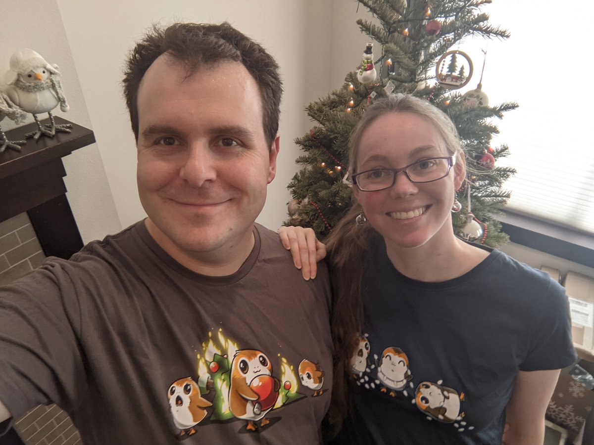 Django and Casey in festive porg shirts in front of Christmas tree
