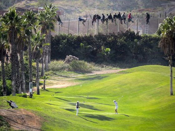 Huge fences that Trump would be proud of separate the colonies from Morocco. There's one overlooking a golf course, which is the subject of one of the most iconic images of our times – migrants atop the fence watching golfers.