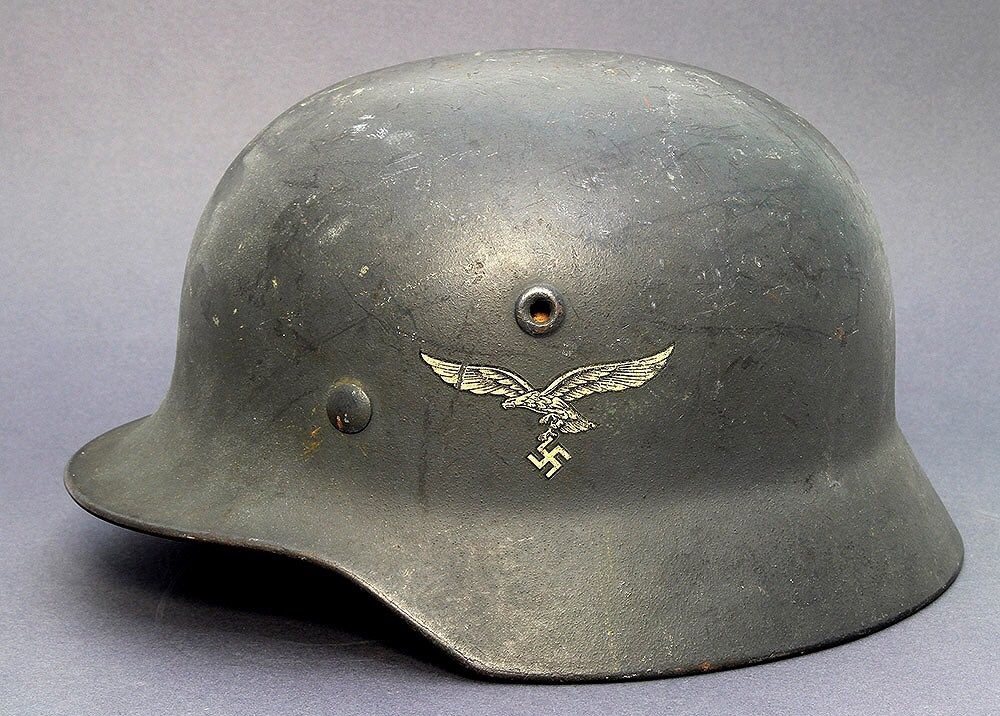 In addition, simplification was required to suit a Wartime industry, so the M40 Stahlhelm included the above measures with the ventilation holes now stamped, replacing the previous separate components. The crown was lowered slightly, too. Arm of service decal was retained. 9)