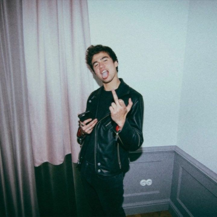 a thread of calum with his tongue out