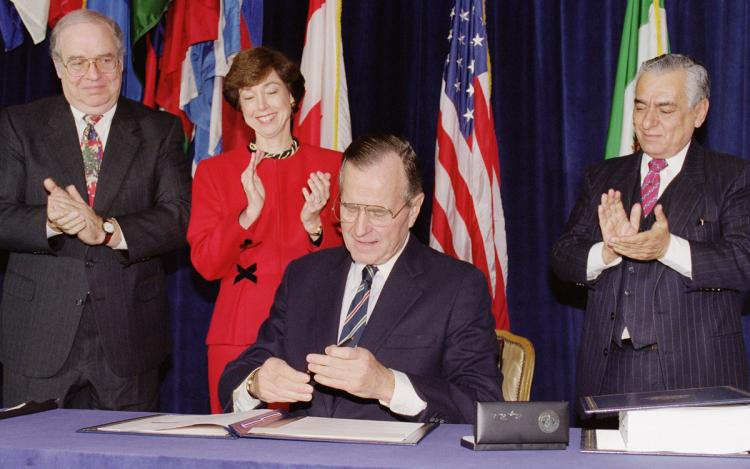 15/ NAFTA was first signed by George Bush Sr. in 1992, approved by congress shortly after, and signed into law by Bill Clinton in 1993. Bush and Clinton promised that it would lower the US trade deficit, usher in new era of prosperity, and good-paying jobs for the middle class.