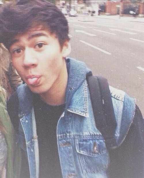 a thread of calum with his tongue out