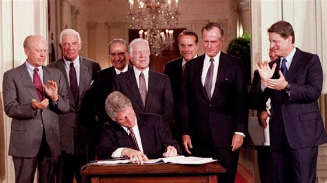 15/ NAFTA was first signed by George Bush Sr. in 1992, approved by congress shortly after, and signed into law by Bill Clinton in 1993. Bush and Clinton promised that it would lower the US trade deficit, usher in new era of prosperity, and good-paying jobs for the middle class.