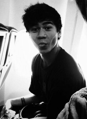 a thread of calum with his tongue out