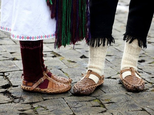 Ogledalo – a small mirror suspended from a chain or silk cord, worn hanging from the kanica; meant to thwart the evil eye. (Bride from Zmijanje. Notice how she averts her gaze and clutches at the mirror)Opanci – oputnjaši of rawhide made from tanned leather by craftsmen