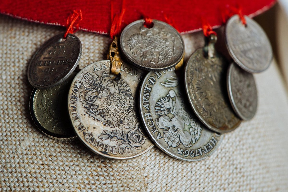Haljina (dress) – a heavy woolen garment that has long sleeves and a bodice like a coat, but a wider skirt.Kapa (hat) – a shallow, red felt cap decorated with silver coins.Đerdan – a necklace of silver coins (not from Bosanska Krajina, just an example on a Serbian woman)