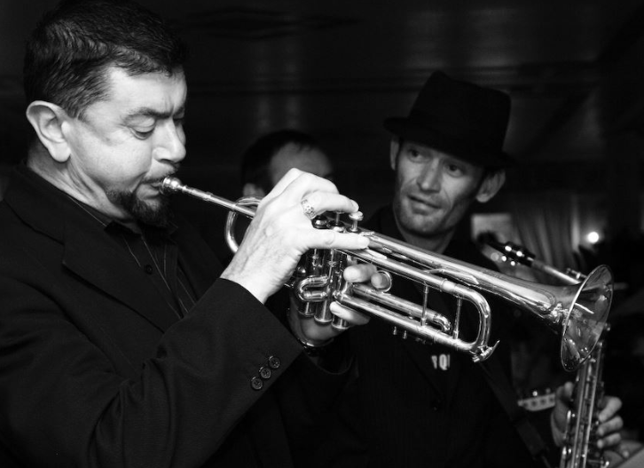 So it is that I, who know almost nothing of jazz, have learned that Paul Bonner was a founder member of the Fallen Angels, who perform still; & here he is, trumpeting away, sax player Tony ‘Rico’ Richardson looking on. Thank you, Google. (4/6)