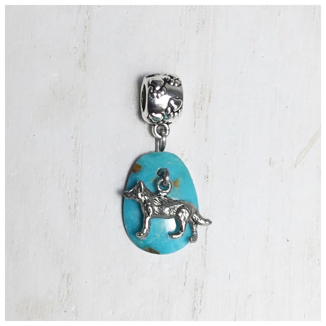 bowden2you's tweet photo. Teeny Tiny #InuitDog #Pewter #Charm attached to a #Turquoise cabochon for a #charmbracelet. The little #pawprint barrel bail is cute! 
Off to #France tomorrow morning 🐺 🐾
Bon Voyage mon Petite Chien ♥️ 🇫🇷 https://t.co/zqweoOUZlI