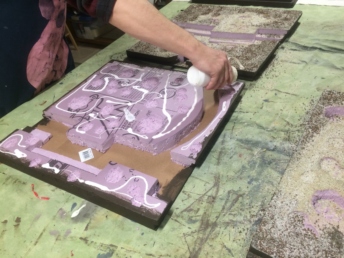 I good friend of mine helped me at this stage, using hos gaming table. We painted the edges and I reinforfced the corners with hockey tape. (How Canadian). Then white glue and mixed large and small pieces of sand.