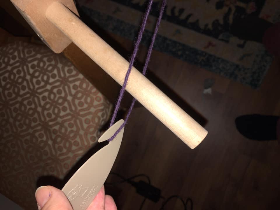 10/ Across the room I have this wooden peg attached to a chair. The loop of the yarn goes over it.