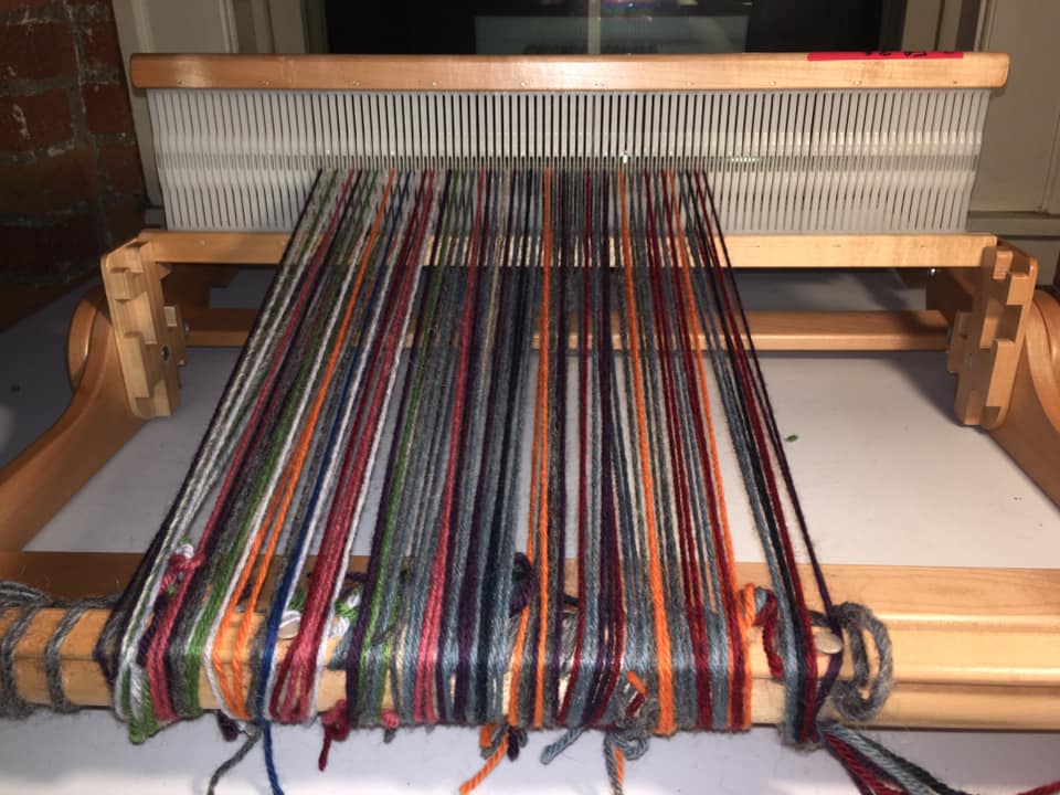 26/ You wind a bunch of yarn onto the roller. This is where you start weaving.