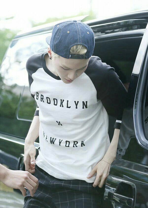 YOONGI WITH BLONDE HAIR AND A BACKWARDS HAT