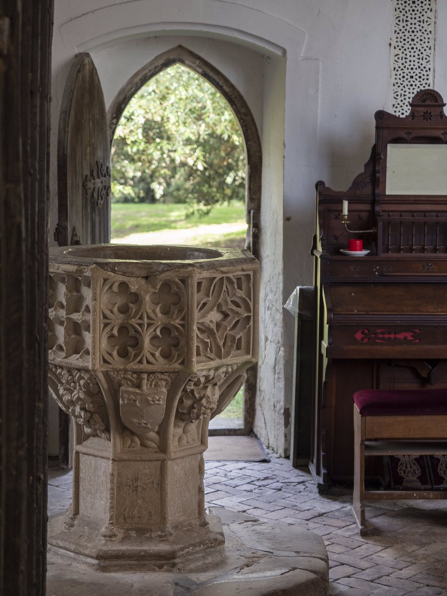 Step beyond this to see the font: an octagonal affair from the same century encrusted with cusped panels, heraldry and foliage. The simple moulded pews also date to the 1400s, as do the glittering fragments of stained glass... 3/7