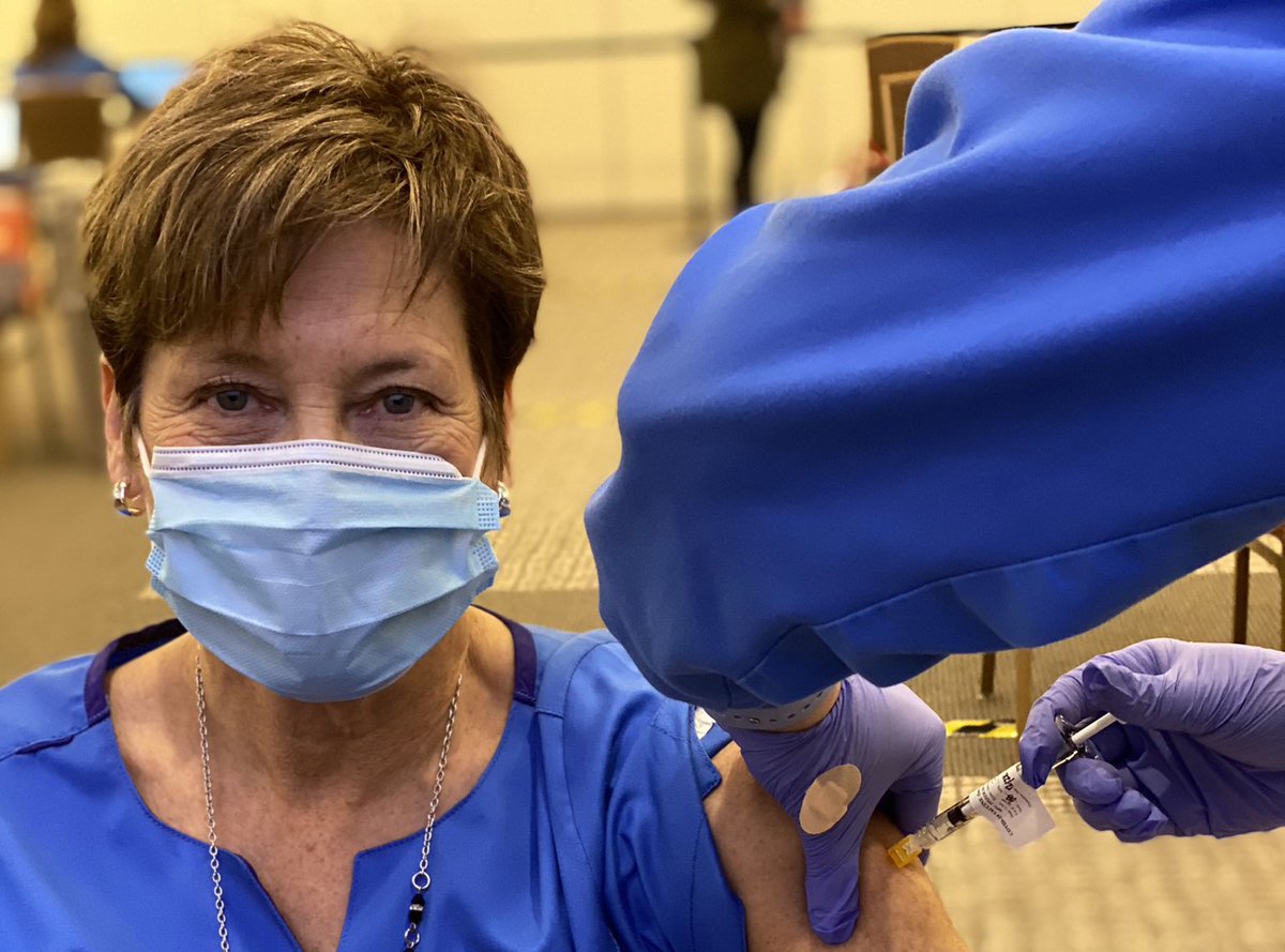 here is a photo of my mom, a nurse practitioner, getting vaxxed today after inadvertently blowing the whistle on Big Pasta