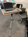 zpr.io/H4B6n Did you know that a camera tripod can be used for more than just cameras, like a light-duty podium/portable desk?  Build a platform that mounts into the tripod head where a camera would otherwise mount. Wide range of height, from coffee-table height to sta