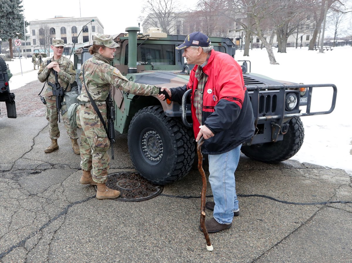 mdesisti's tweet image. More photos from the scene right now in #Kenosha near the courthouse. That first one is a Marine vet. shaking a guard's hand. #JacobBlake