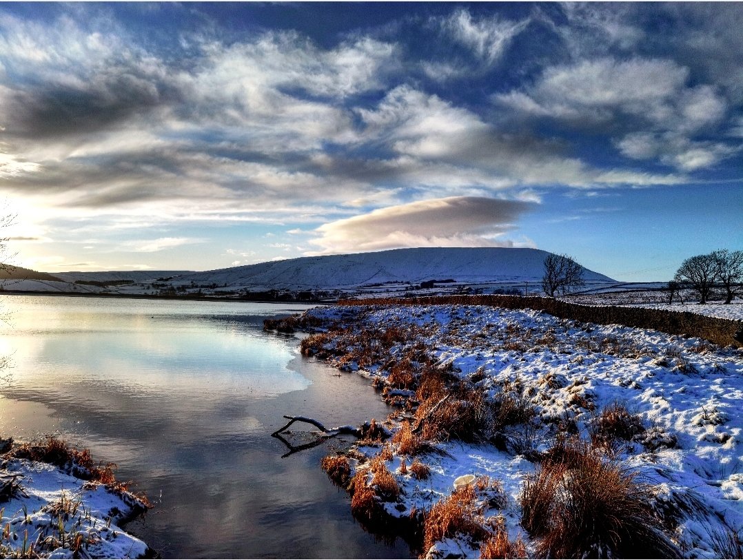 Pendle Rose flat against the sky, like a paper cutout.