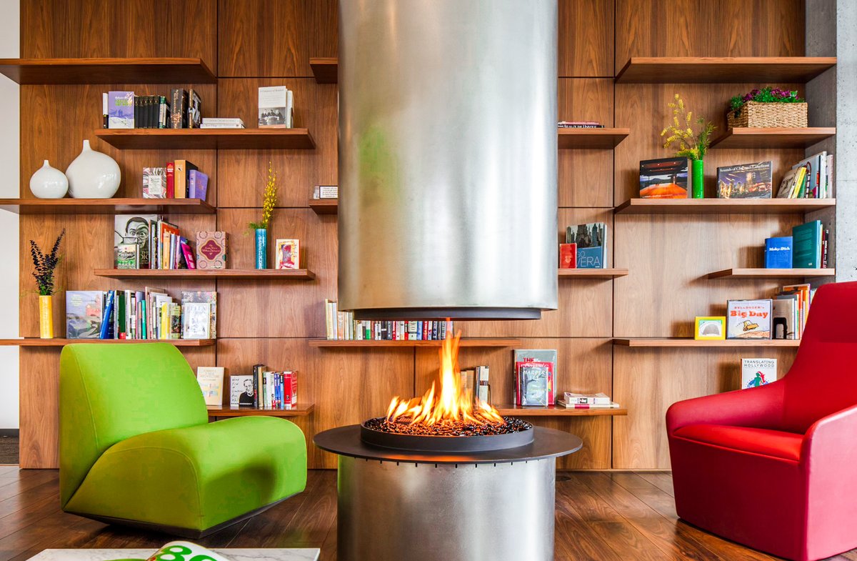 OptimaSignature's tweet image. Our library is truly the perfect space to cozy up by the fire with your favorite read! 🔥📚#BeAnOriginal