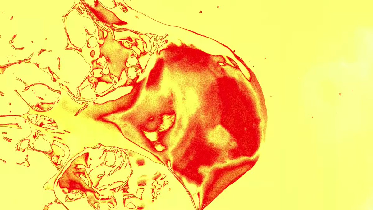 It took some effort, but I found the original clip they used for that droplet splatter clipSadly, the source doesn't reveal anything new (they obviously edited the colors for the teaser), they just wanted to show this imagery https://www.shutterstock.com/video/clip-1061107375-liquid-oil-paint-gold-ball-splatter-drops