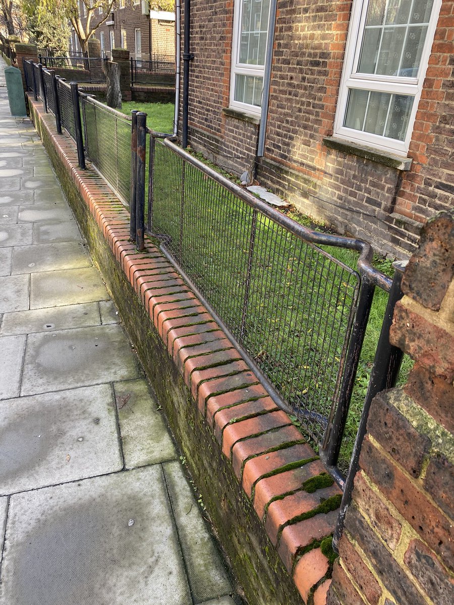 As often found on London’s housing estates, these fences are made from WW2 Air Raid Protection stretchers. 600,000+ stretchers were made for civilian use in the Blitz; but surplus after the war. Estates’ railings had gone for War Effort: stretchers were recycled to replace them.