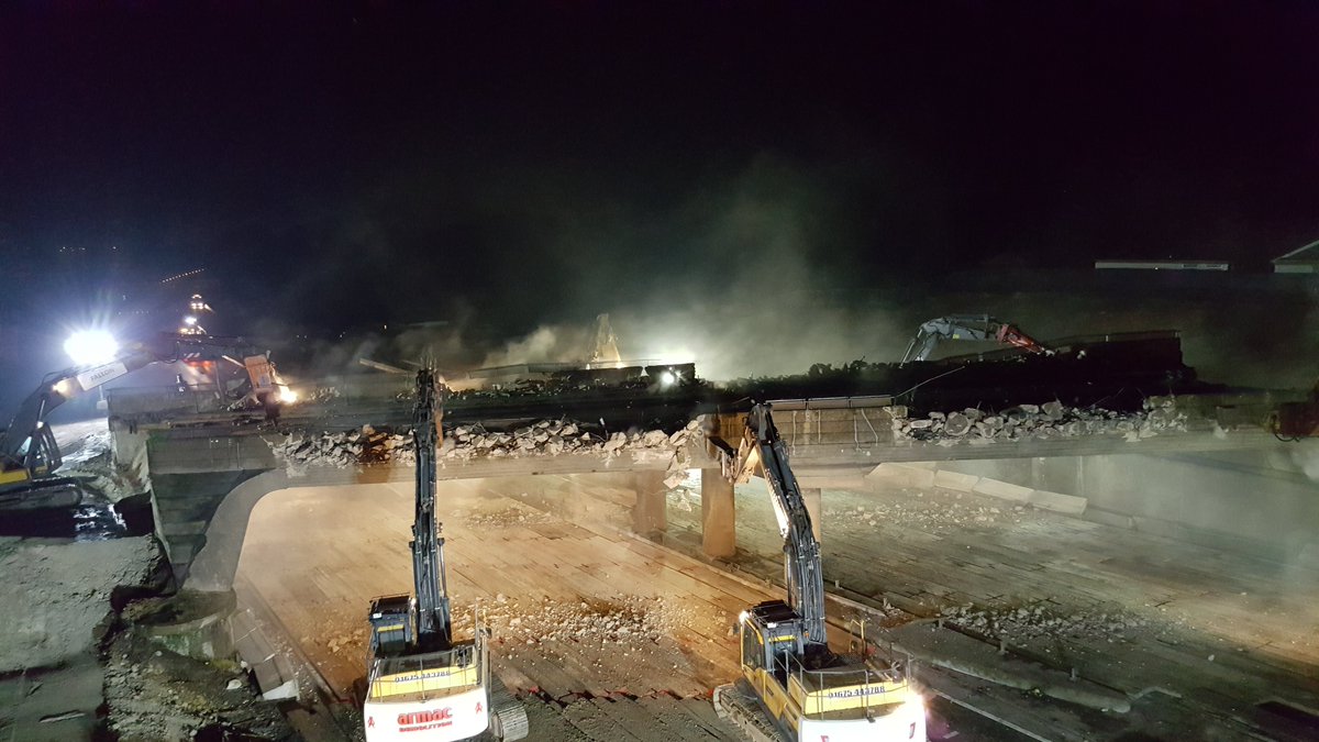 Demolishing: Excavators fitted with giant hydraulic breakers and claws munch away at the bridge, breaking it down. Seen a time-lapse of ants devouring an animal carcass? It’s much the same.