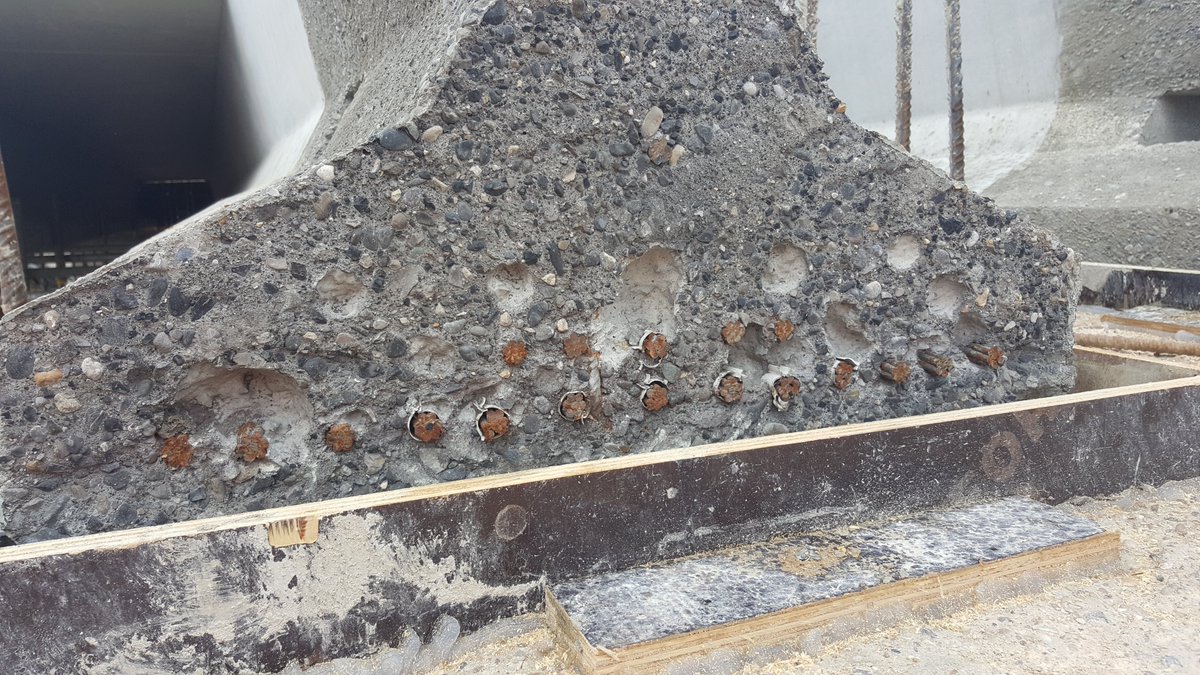 Concrete beams can be pretensioned for better strength. Steel wires are stretched through the beam mould, putting them under strain. The concrete is poured and once cured, the strands are released. The strands are sticking out the end of the beam in these pictures.