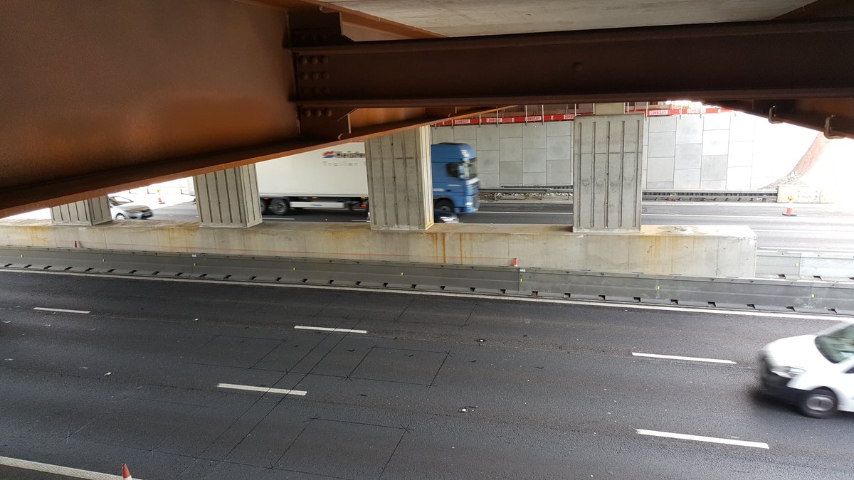 This is called ‘weathering steel’. The beam is allowed to rust, building up a layer approx. 1.5mm thick. The rust provides a protective barrier to the main beam core. The thickness of rust is monitored to ensure it's providing protection.