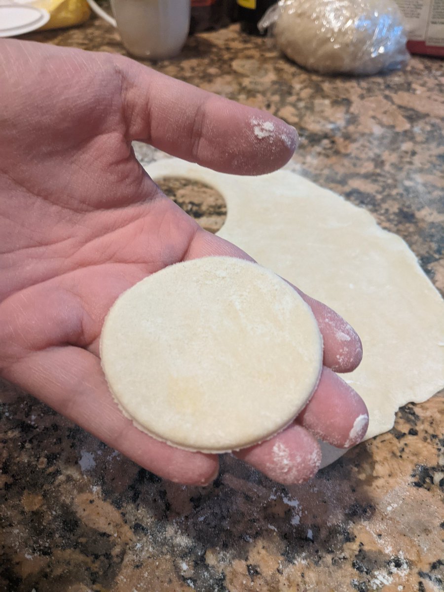 With your dough hydrated and your filling ready, it's time to assemble! Roll out the dough in portions, taking care to keep the rest sealed so it does not dry out. Cut out circles using something circular. I used a cup.