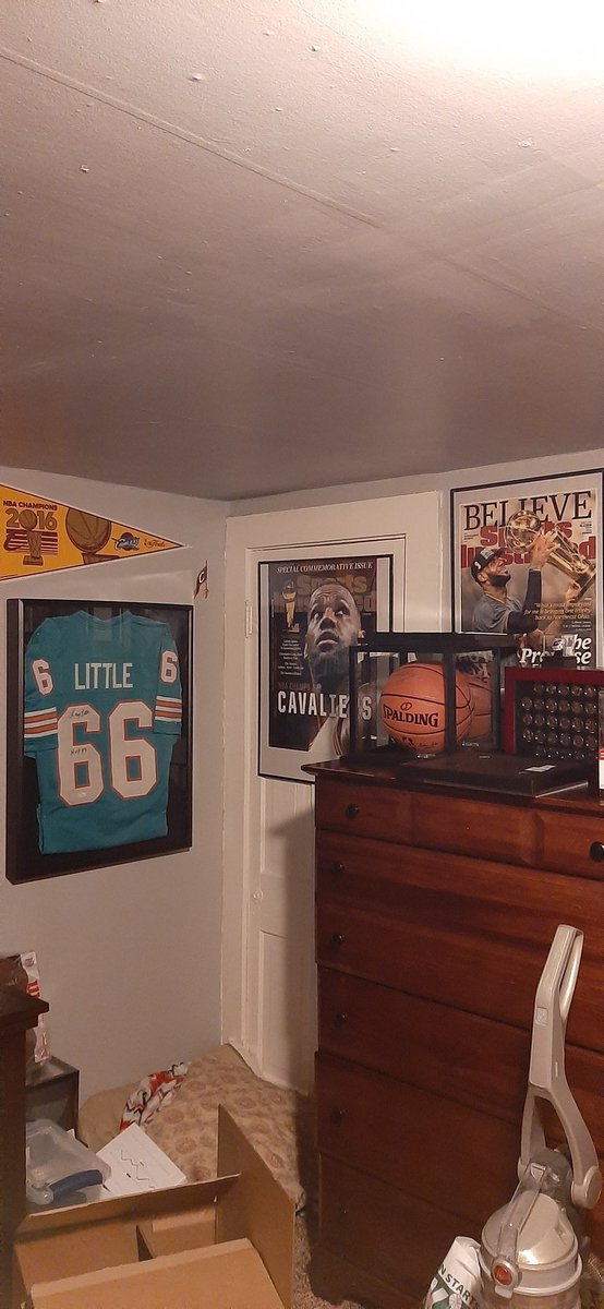 GHeaven2704's tweet photo. @Tua hung up there with my new @DanMarino signed helmet and Sports Illustrated HOF cover edition(anyone else have this?) #LarryLittle had to move over and invade the @cavs 2016 #Championship memorabilia. Great way to end 2020 with the auto jersey! #TuaTime #FinsUp @MiamiDolphins https://t.co/FsIefkzUCz